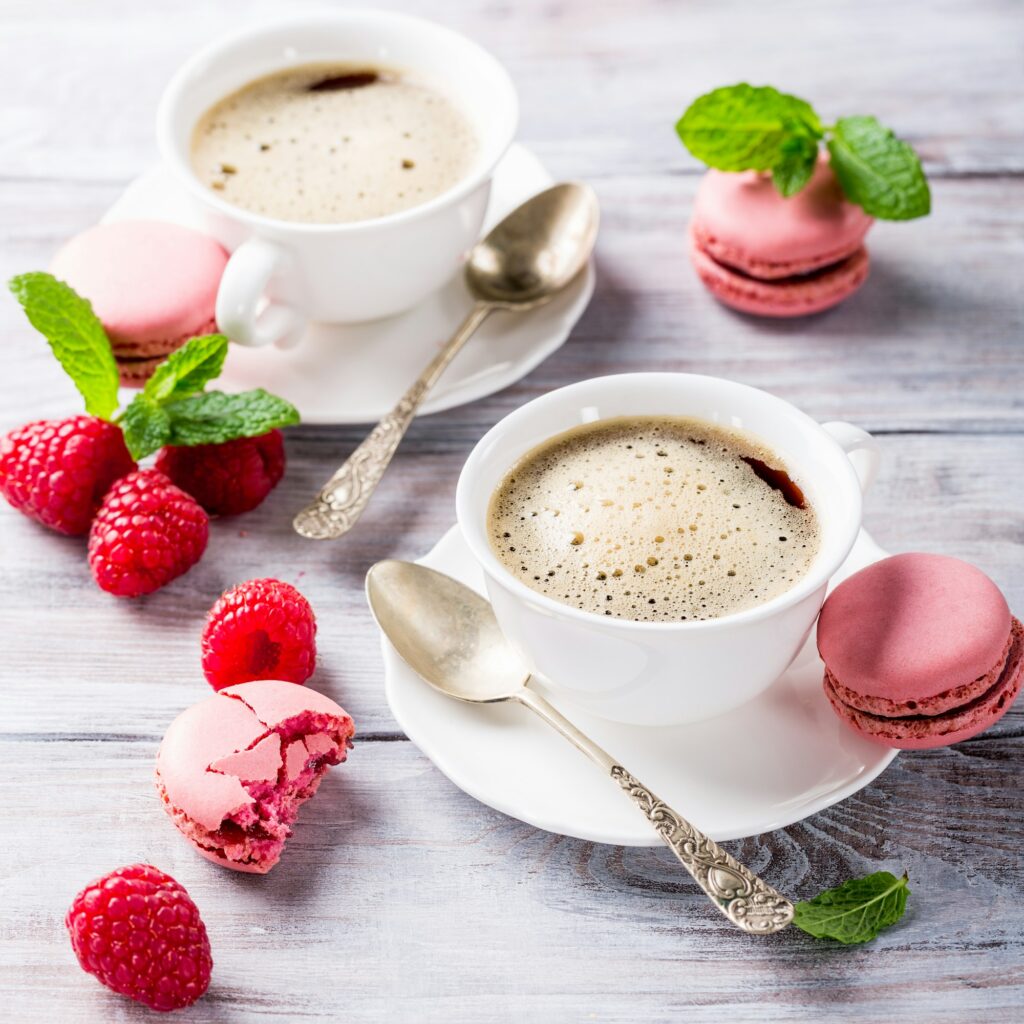 Cup of coffee with french raspberry macaroons